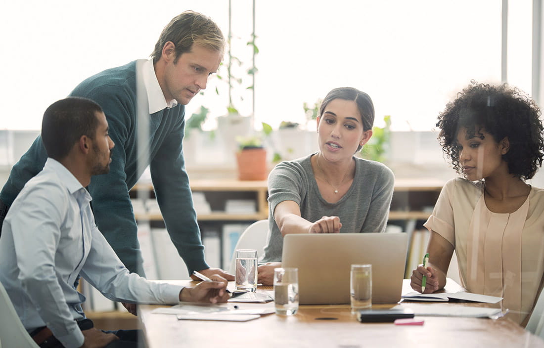 Employees gathered around a computer