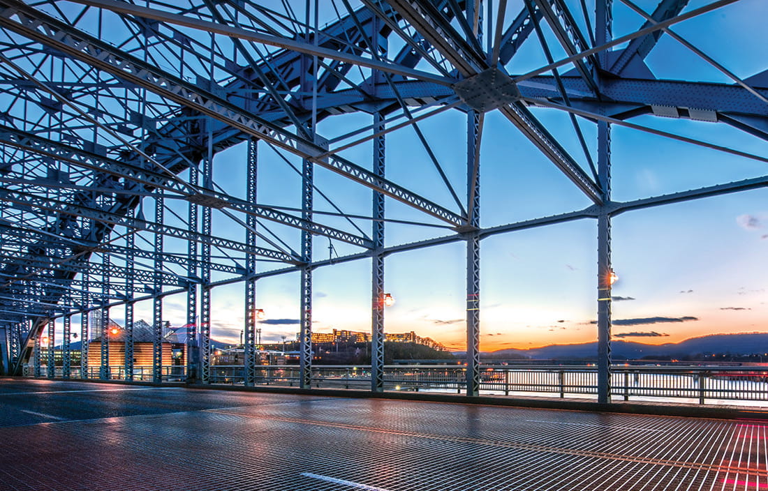 Image of bridge structure with sunset in background