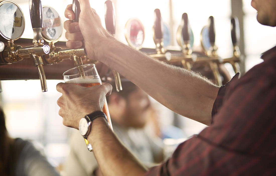 Bartender pulling beer tap