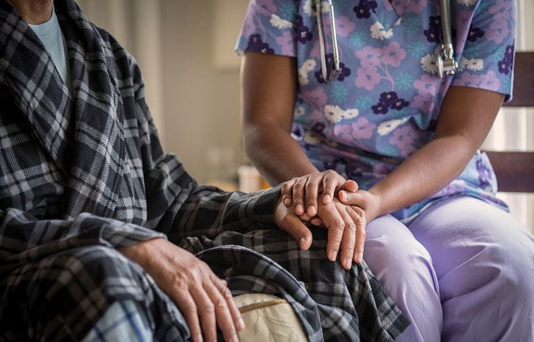 Nurse holding a hand 