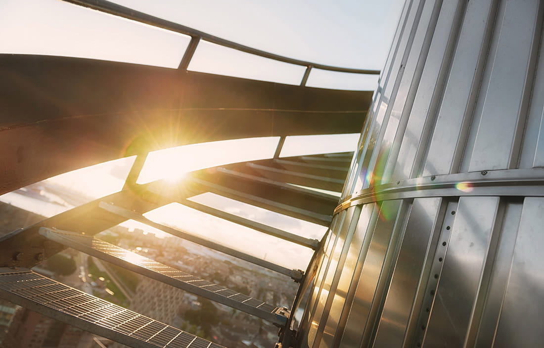 Image of open metal stairs wrapping around a building.