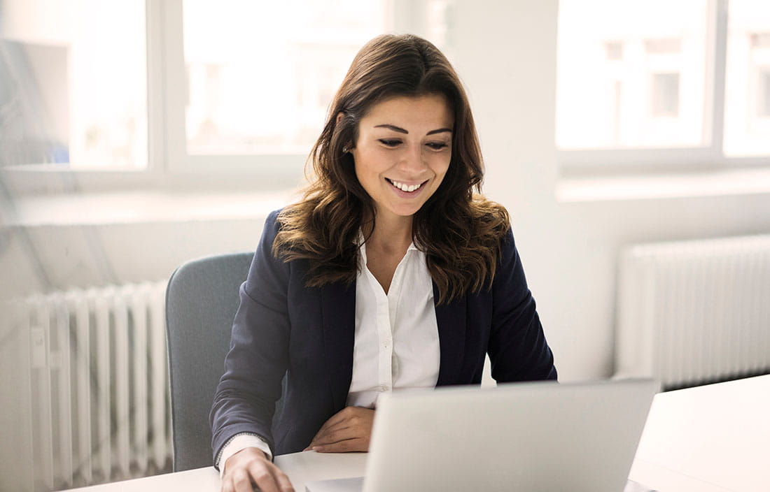 Woman sitting at desk on a laptop