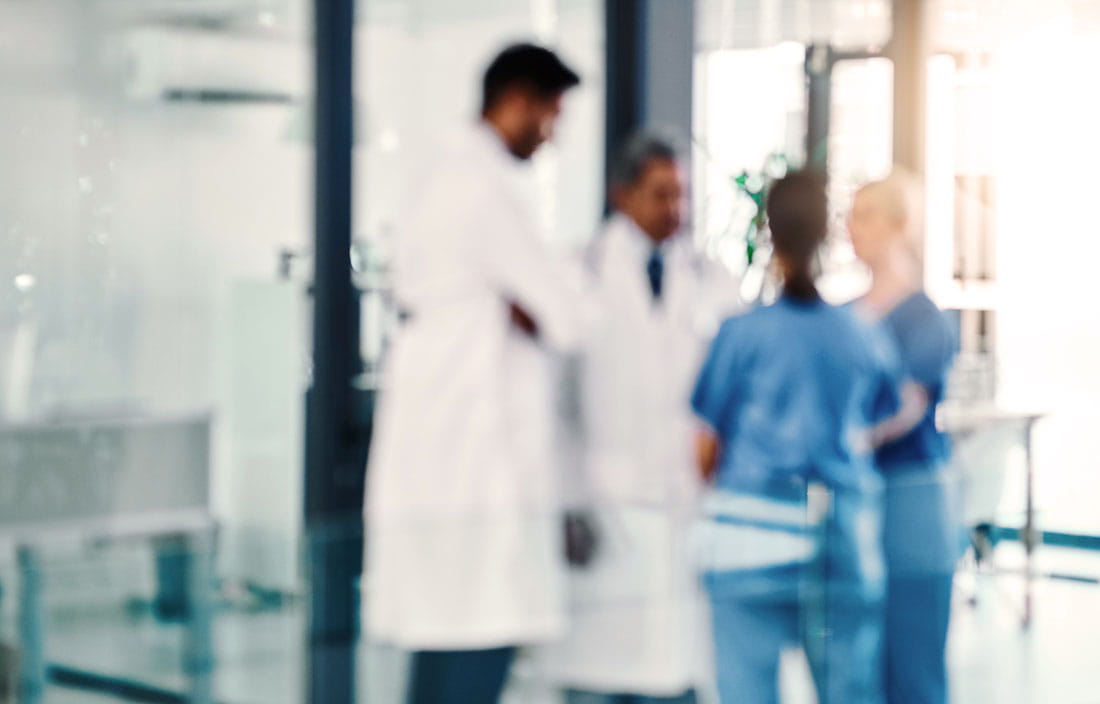 Medical workers in a circle talking