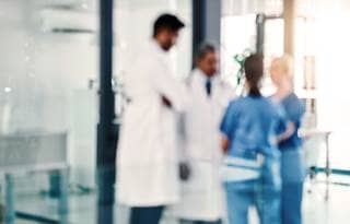 Medical workers in a circle talking