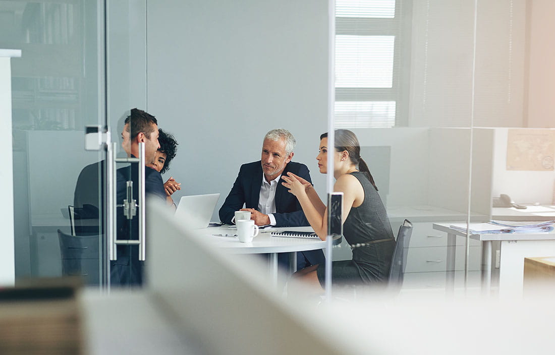 Business professionals in a modern conference room discussing transfer pricing.