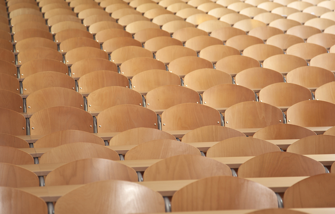 Empty wooden chairs in a lecture hall in a school. 
