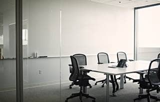 Empty conference room with a glass door entry. 