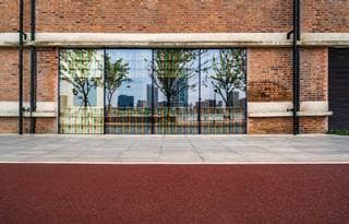 Street view of a sidewalk and storefront glass window display.