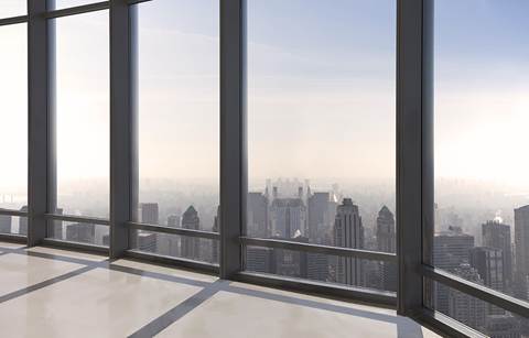 Skyline view of a city during the day looking out a window.