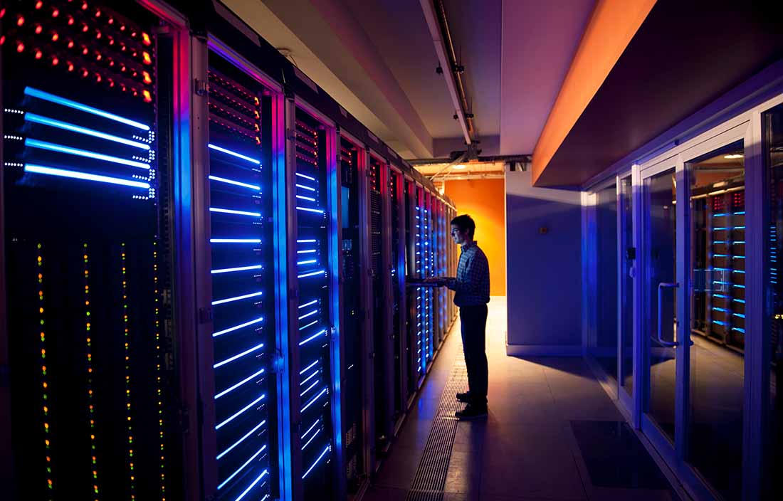 A cybersecurity professional working in a server room.