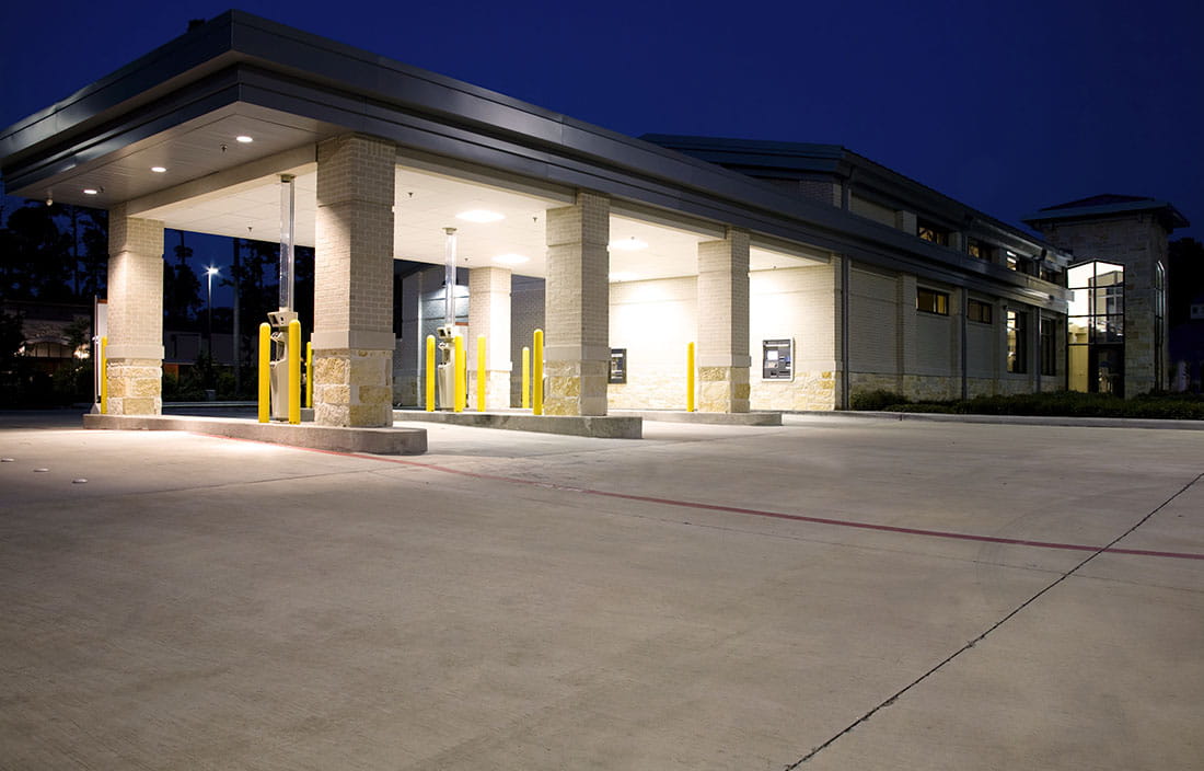 Drive thru of a bank at night time.