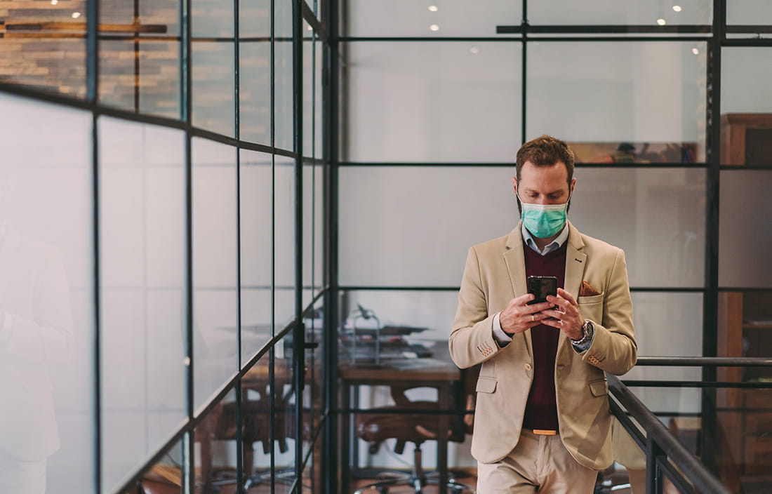 Higher up business executive reading about the Main Street Lending Facilities news on his phone.