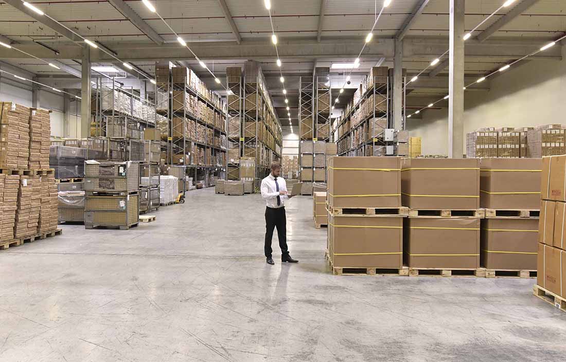 Man standing in a warehouse, checking stock