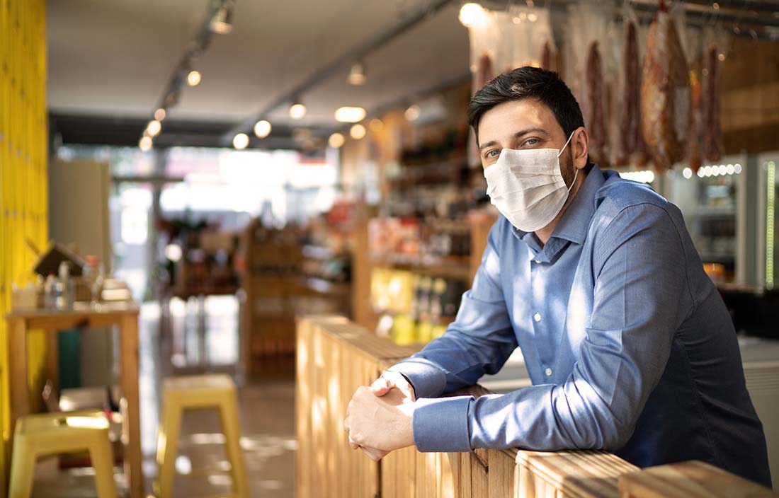 Photo of a small business deli owner in his shop.