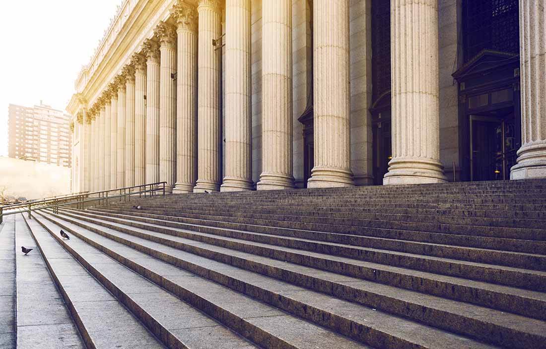 Outside stairs of a building with big columns