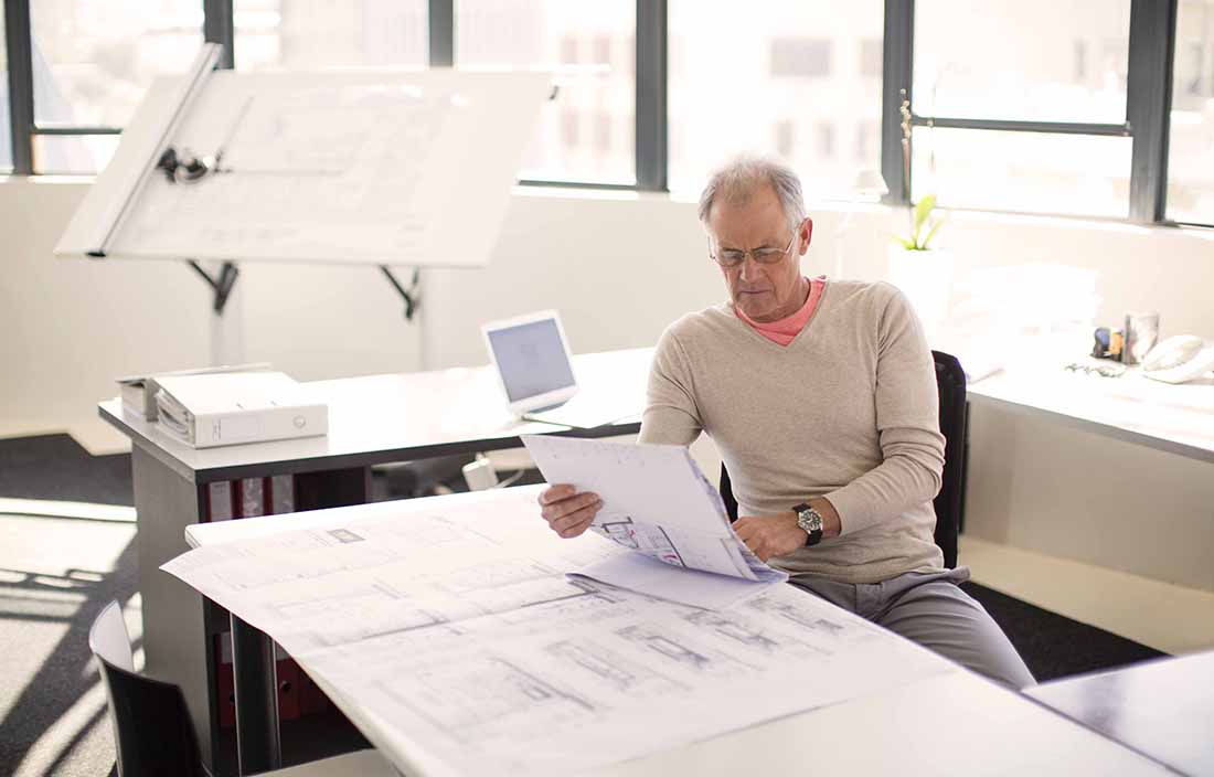 Man sitting at a desk reading documents