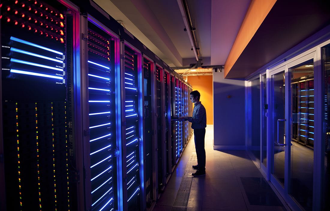 IT/cybersecurity professional in a server room.