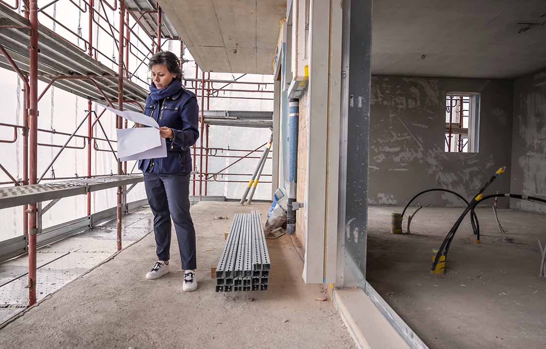 Woman looking at plans at a construction site