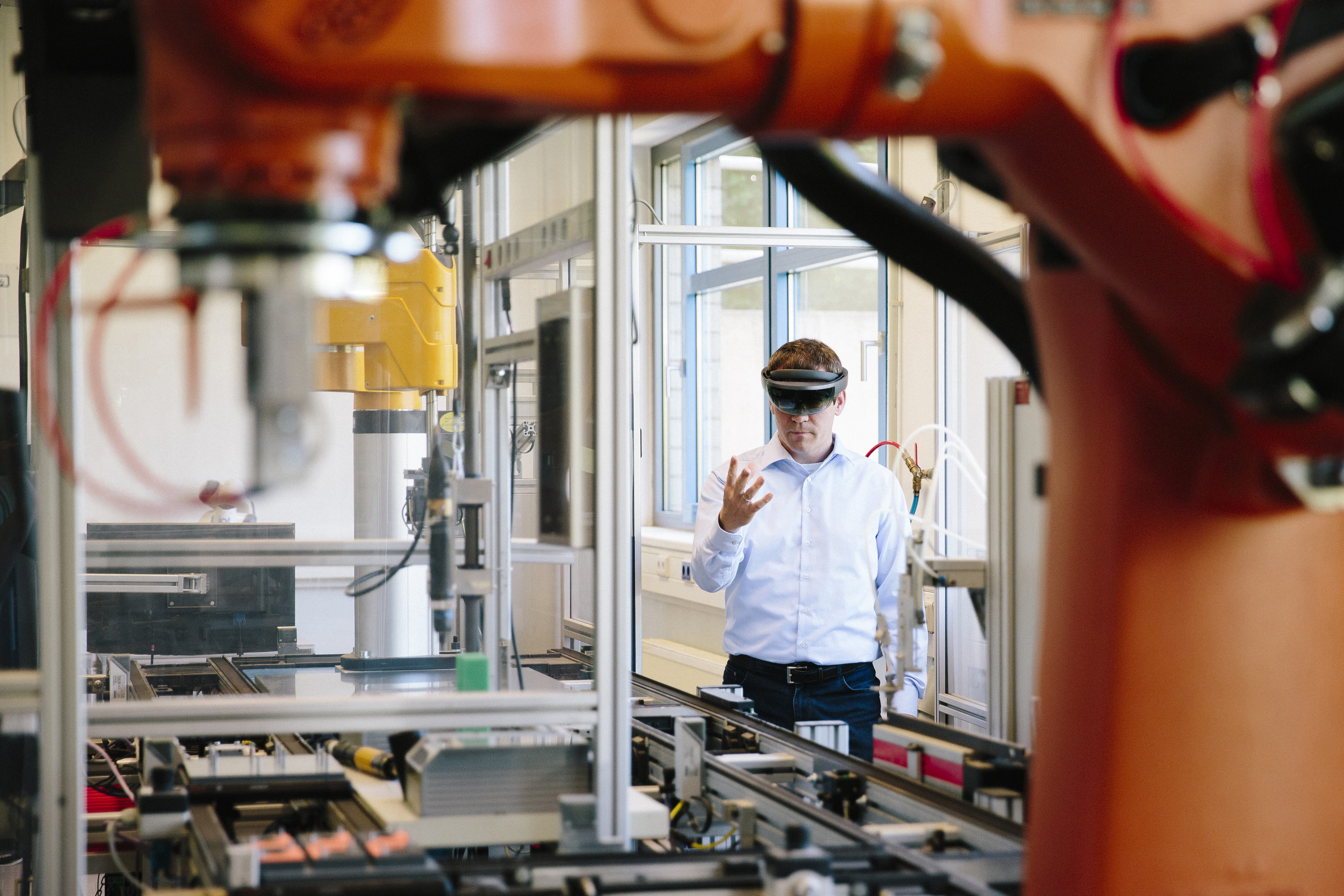Man in a manufacturing setting using VR goggles.