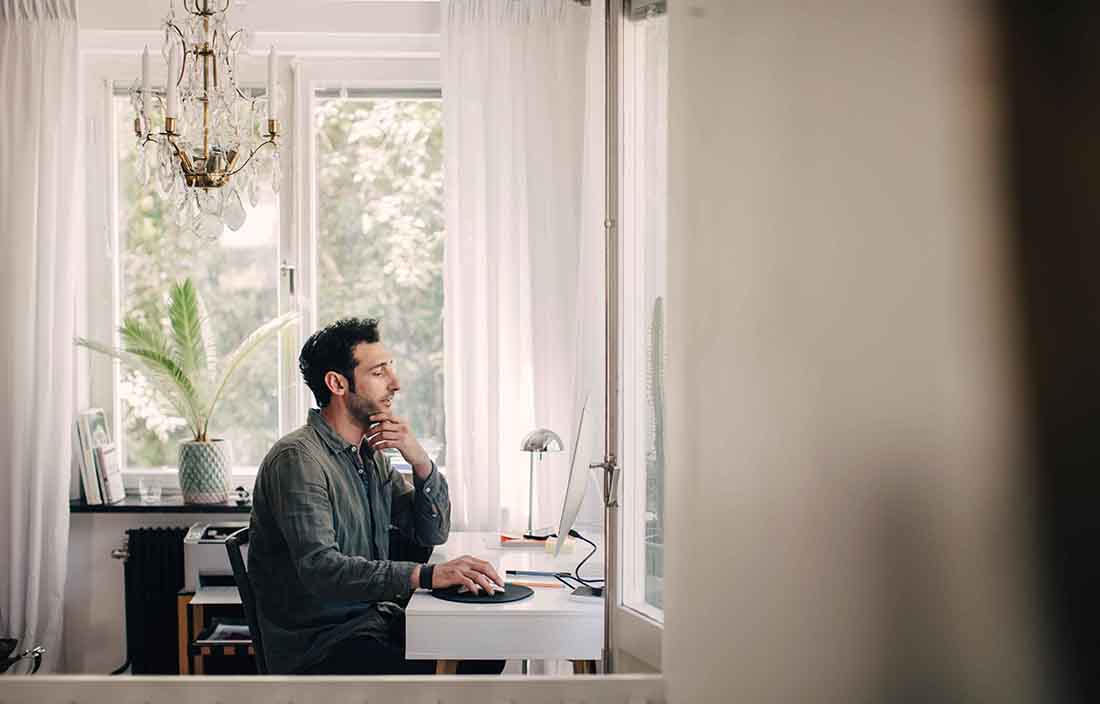 Man sitting at a desk on a computer