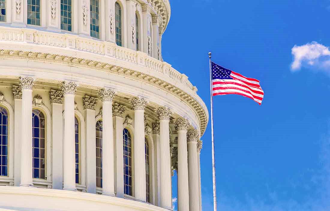 American flag next to capital building