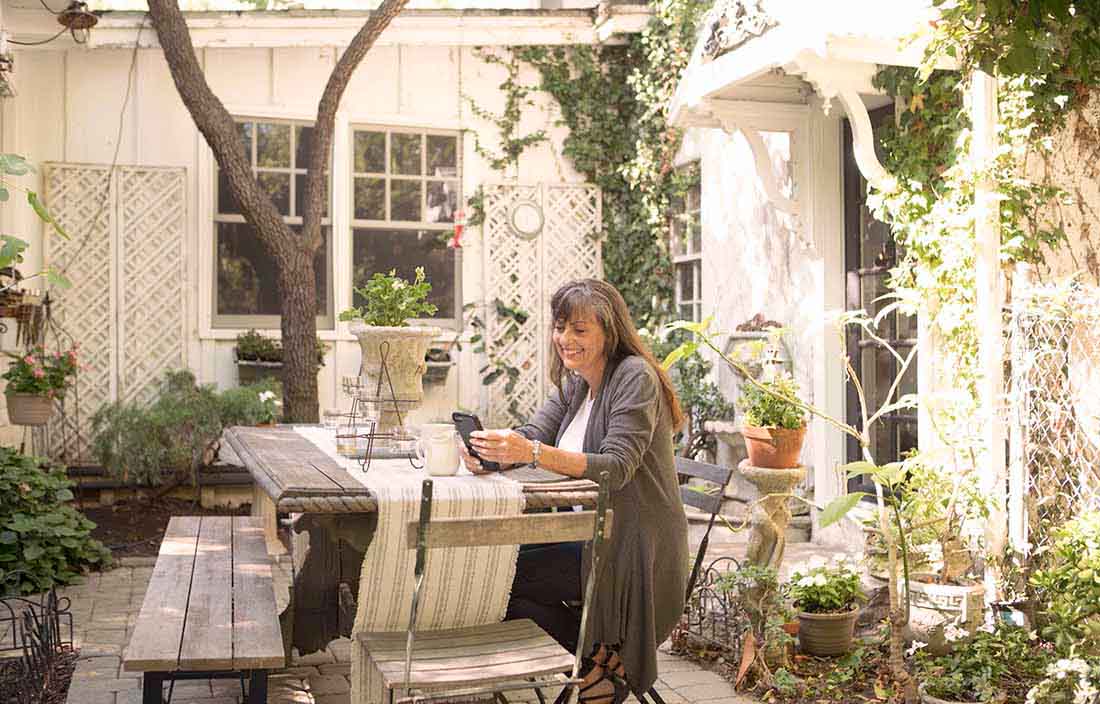 Adult on device in backyard