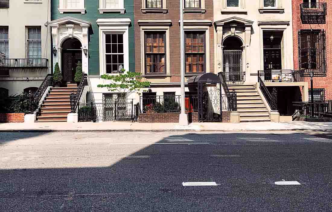 View of a street with apartments in the distance.