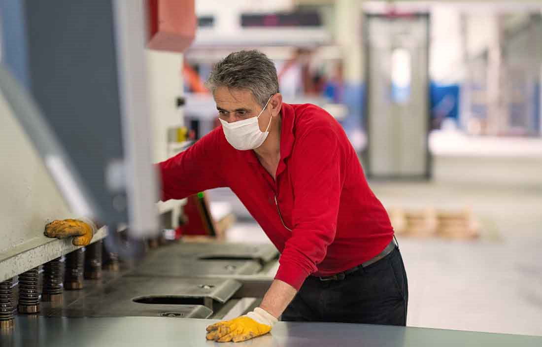 Automotive worker by a machine.