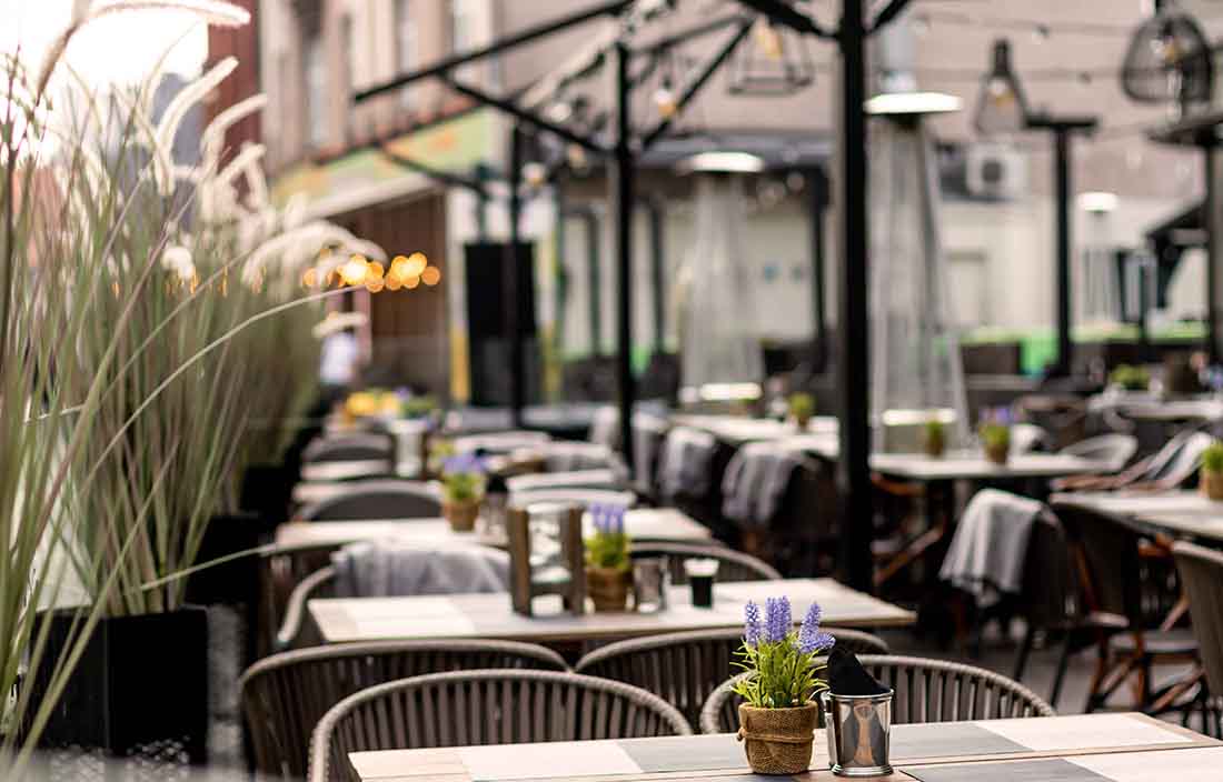 View of an outdoor eating area with empty seats.