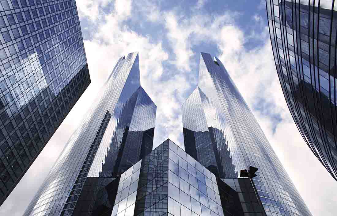 Angled view looking up at city skyscraper buildings.