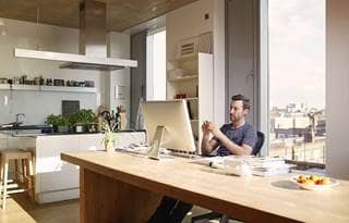 Businessman working in casual clothes in a modern home office.