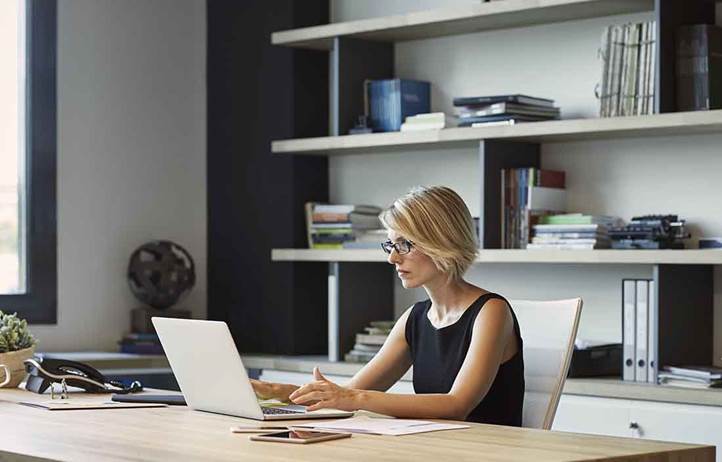 Business professional using a laptop at their desk.