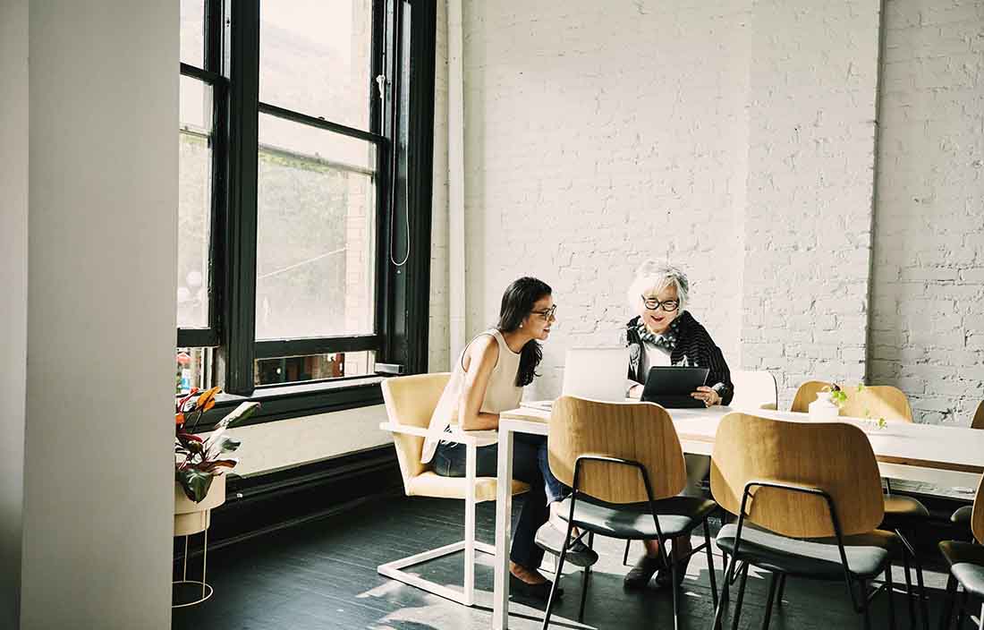 Two business professionals having a meeting in a conference room.