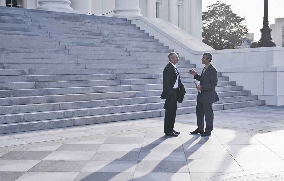 Two professionals on building steps