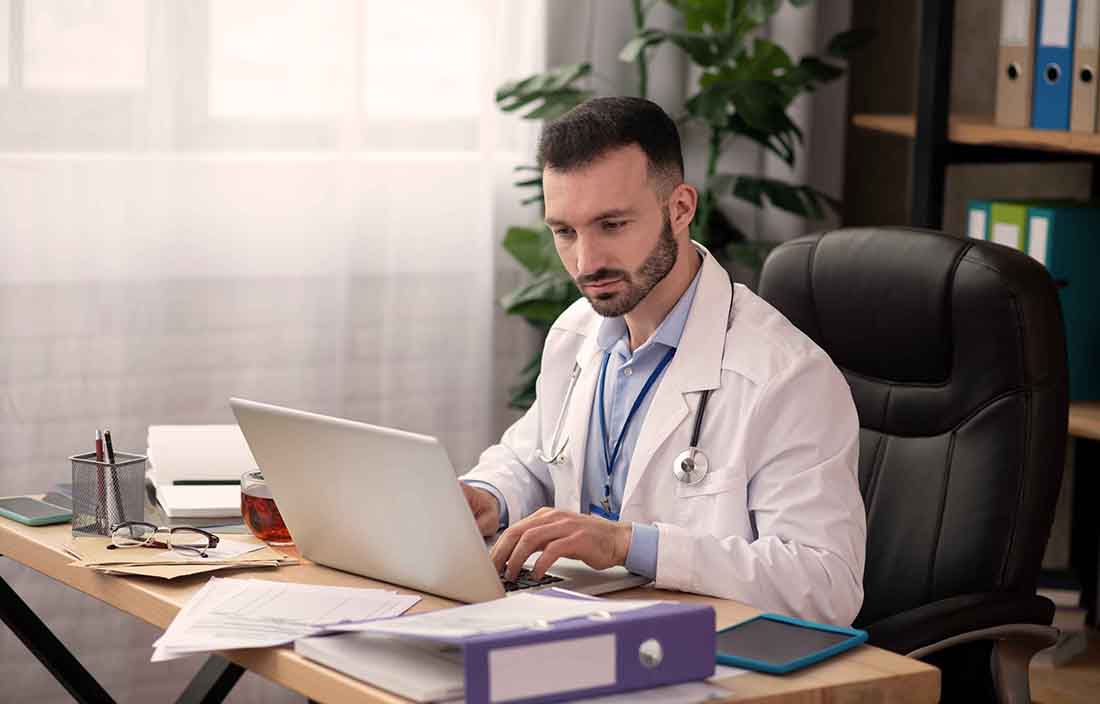 Image of a doctor using a laptop computer.