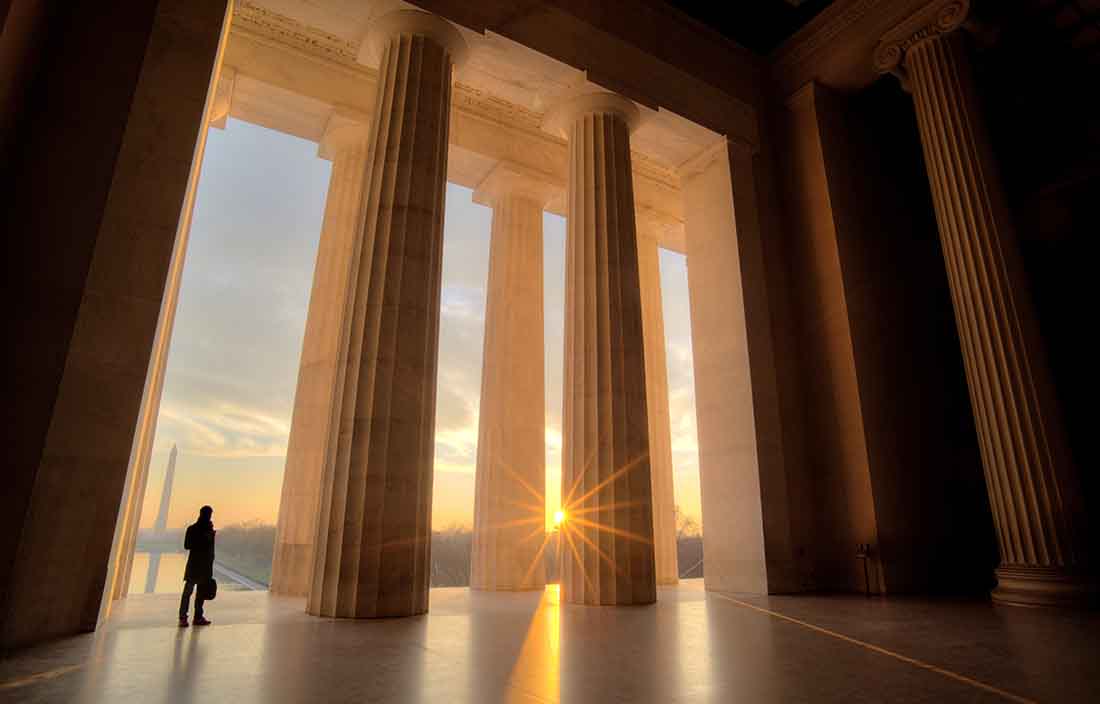 Businessman inside Lincoln Memorial at sunrise