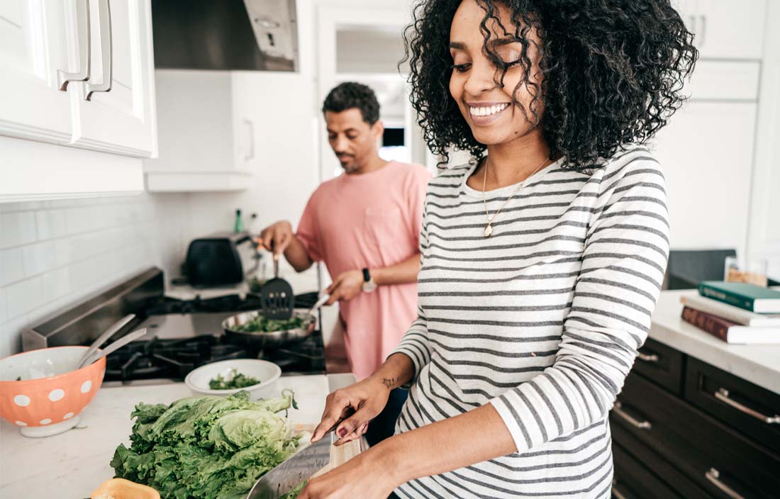 A person cooking in a very modern kitchen.