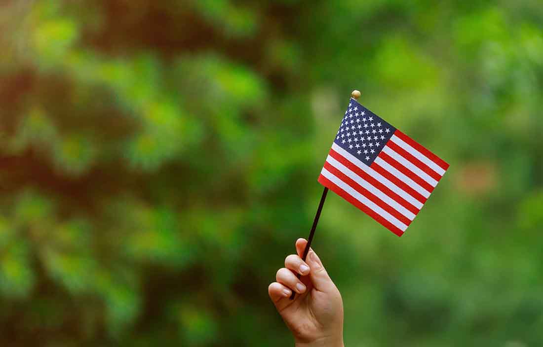 Close-up view of a mini American flag being held.