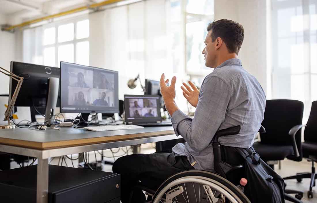 Business professional in a wheelchair taking part in a virtual call.