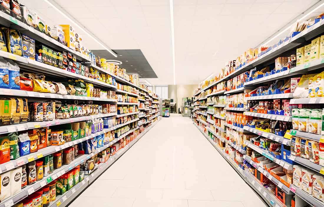 View of an aisle of food packages in a grocery store.
