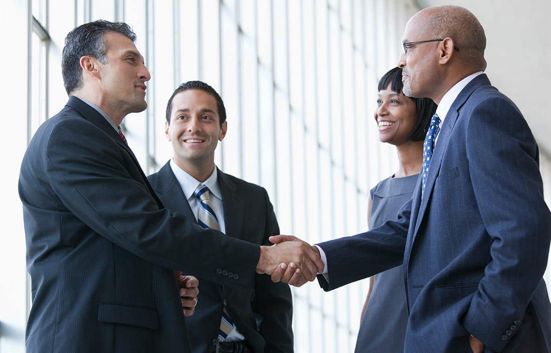 Two business professionals shaking hands.