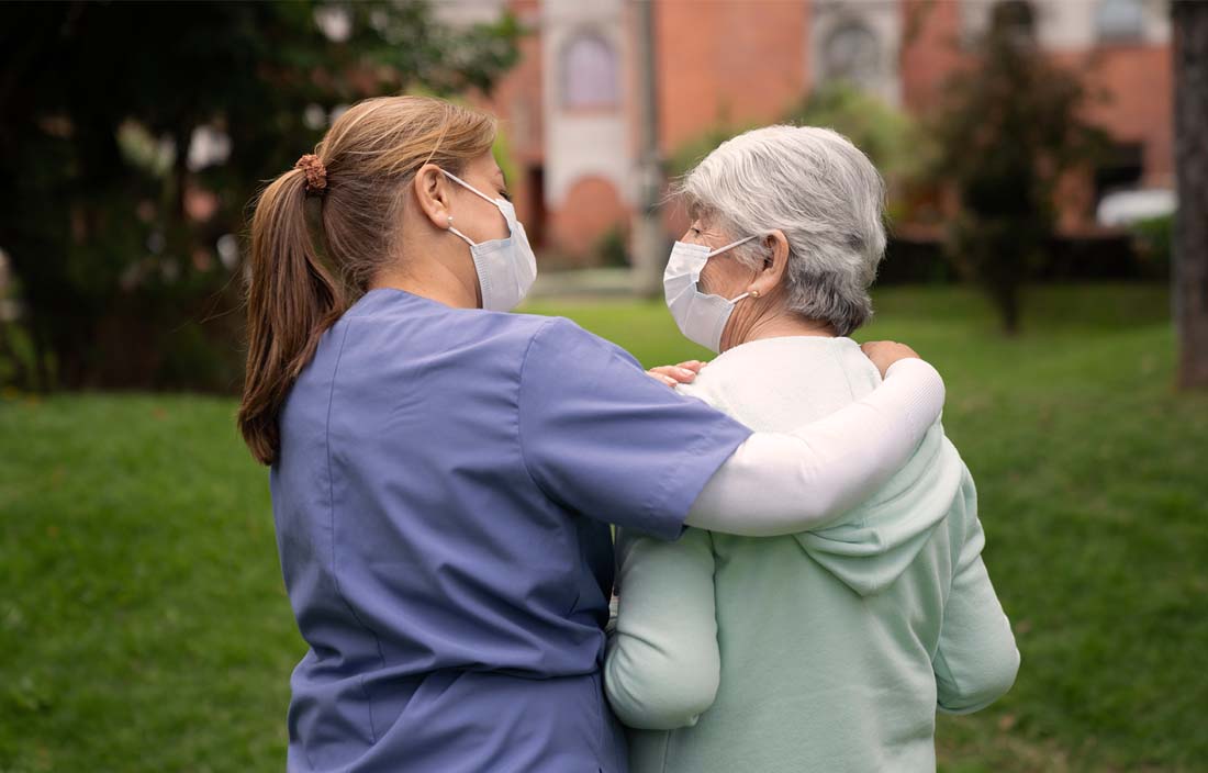 Nurse walking with an elderly patient.