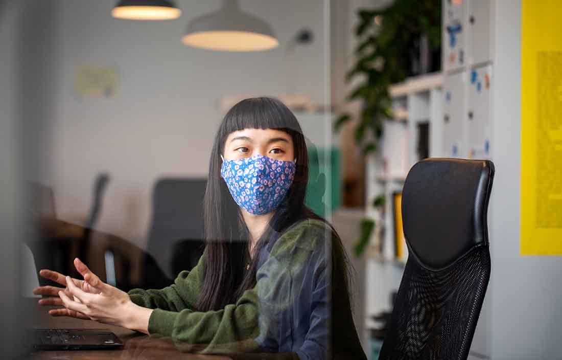 Business professional wearing a protective facemask.