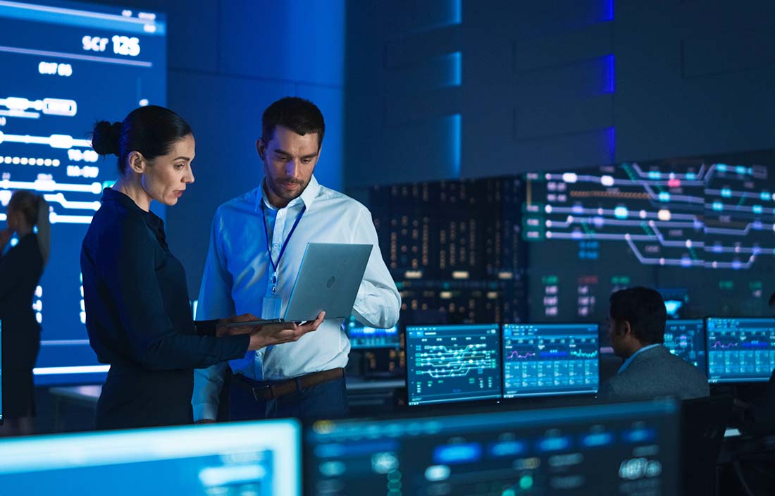 Two business professionals looking at a laptop