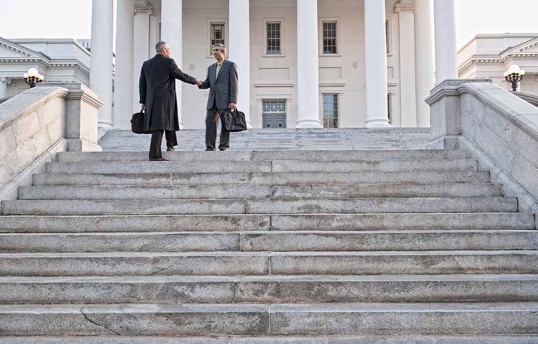 Business people walking down steps.