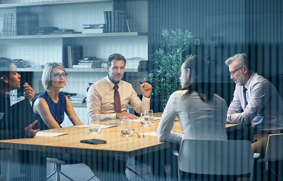 Group of business professionals in a conference room.