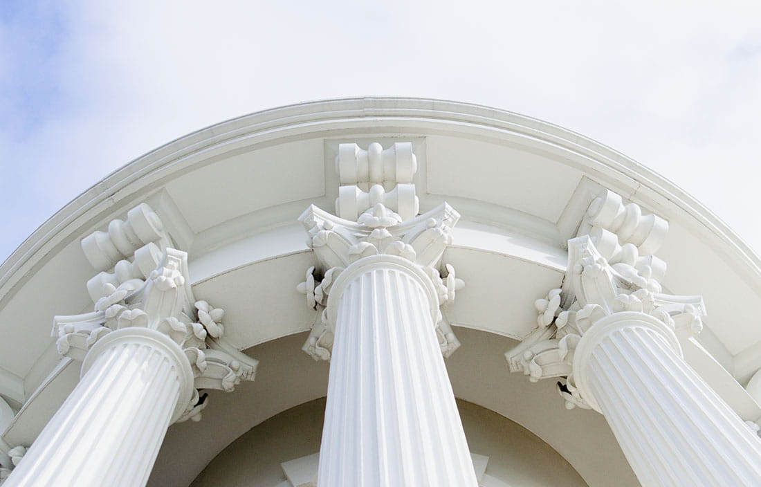 Close-up view of arches of a government building.