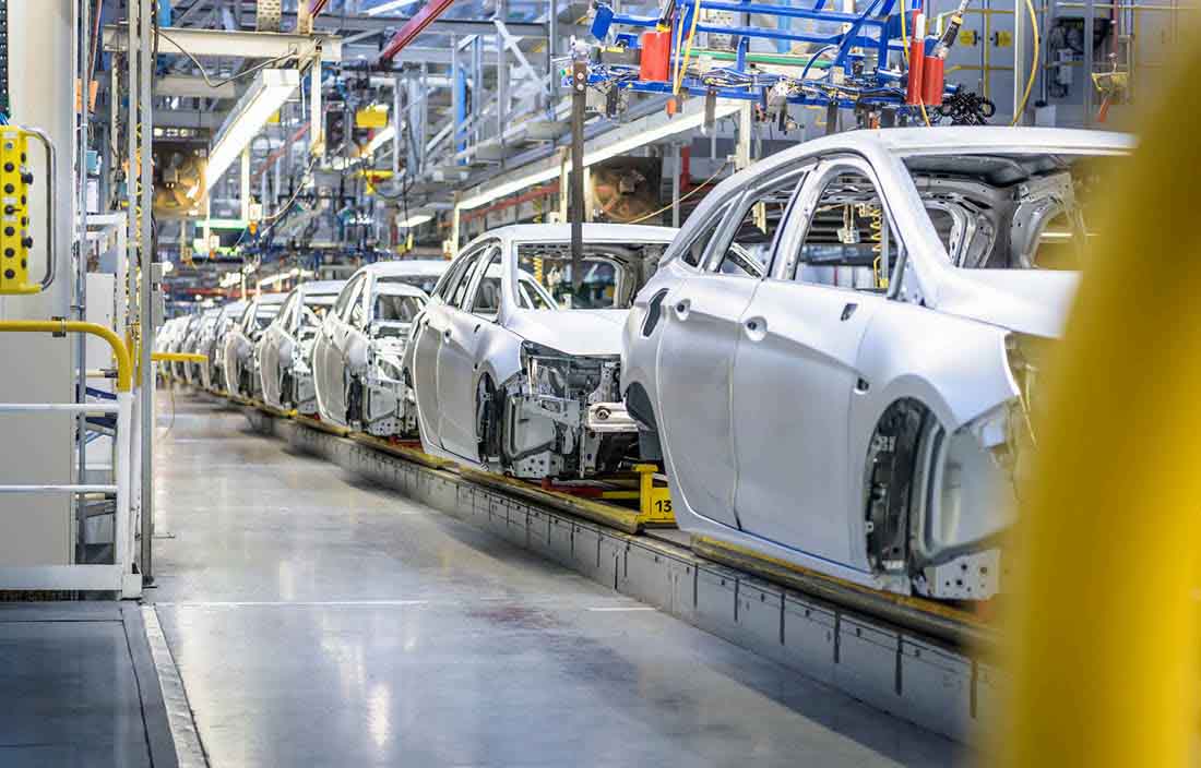 Vehicles being manufactured in a factory.