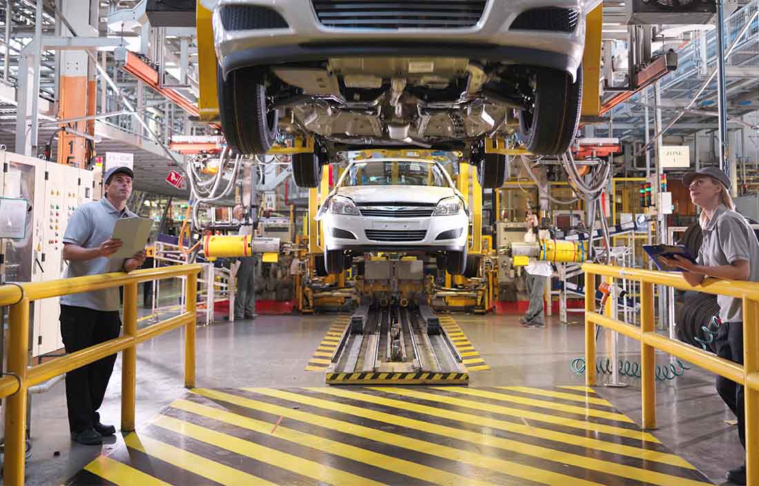 Vehicles being assembled in a factory.