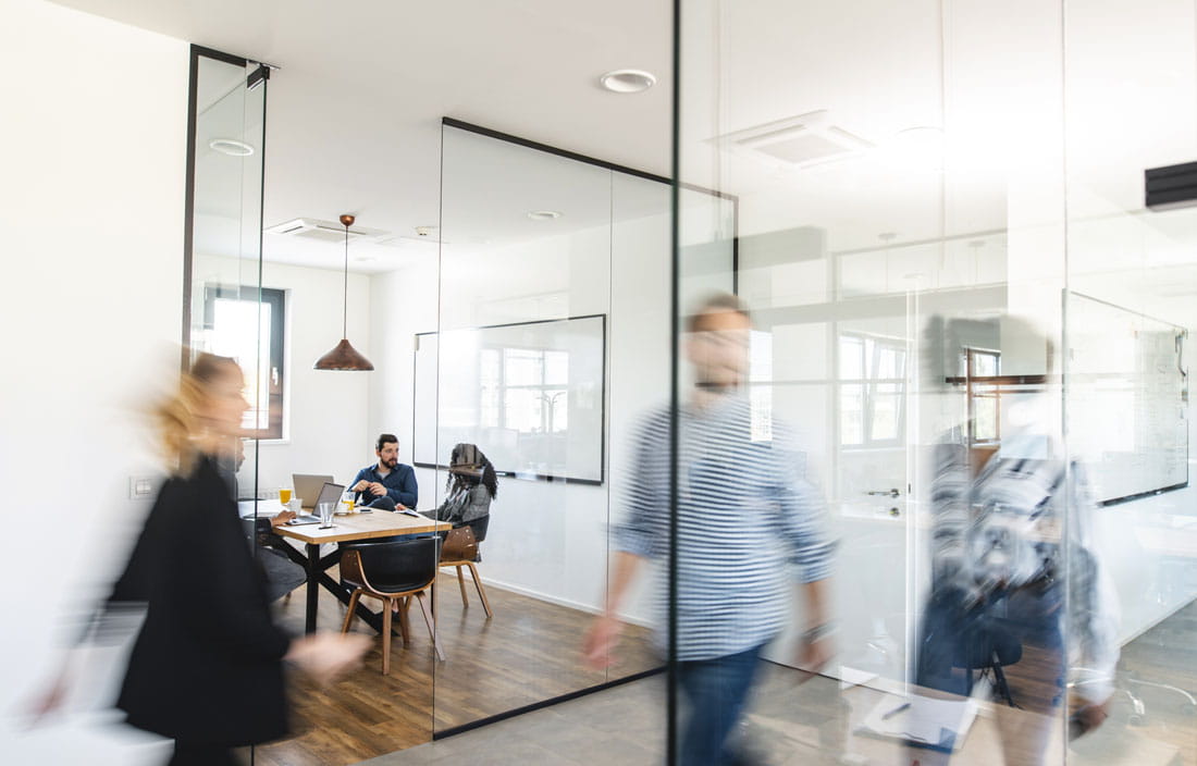 Business professionals walking in an office.